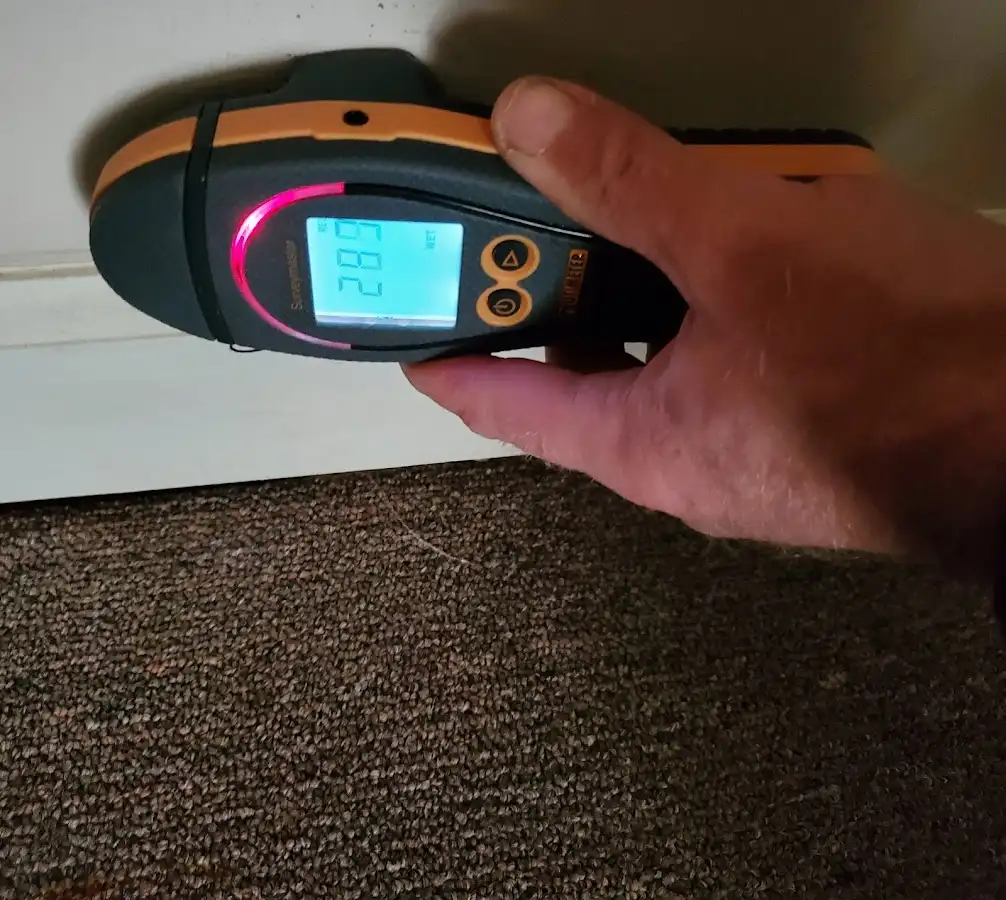 Moisture detection at baseboard during Storm Damage Restoration in Ashland